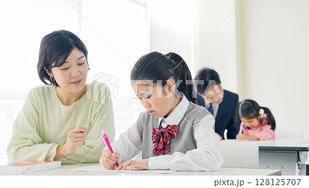 女の子に指導する女性教師 128125707
