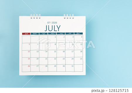 July 2026 Monthly desk calendar for 2026 year on blue color background. Flat lay. July 2026 Monthly desk calendar for 2026 year on blue color background. Flat lay. 128125715