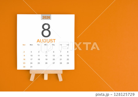 Calendar page for August 2026 with wood easel on orange color background. 128125729