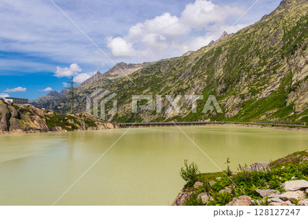 View of the artificial lake Grimselsee - hydroelectric reservoir for Grimsel Pass Dam in Bernese Oberland, Switzerland 128127247