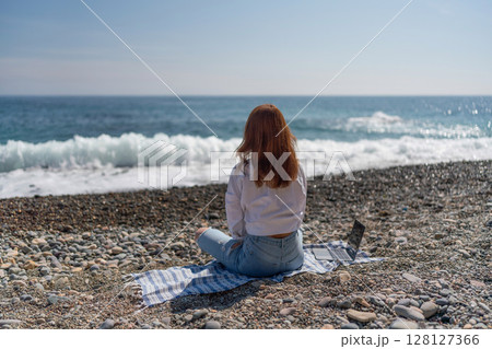 Beach Laptop Woman: Girl works on shore during day for freedom lifestyle, relaxed. 128127366