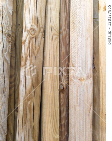 Stacked wooden planks and logs close up 128127955