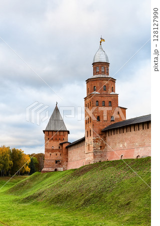 Autumn landscape with Novgorod Kremlin is fortress in Veliky Novgorod, Russia. Veliky Novgorod Kremlin in autumn day with dramatic cloudy sky. Autumn landscape with Novgorod Kremlin is fortress in Veliky Novgorod, Russia. Veliky Novgorod Kremlin in autumn day with dramatic cloudy sky. 128127990