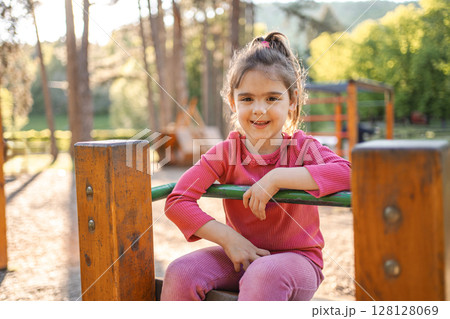 Active cute little girl on the playground Active cute little girl on the playground 128128069