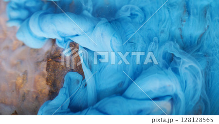 Underwater fume. Ink background. Blur blue color smog twirling pigment particles spreading on acrylic wooden bark art abstraction. 128128565