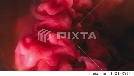 Ink background. Liquid splash. Blur pink red color water swirling smog acrylic particles waving on creative dark black abstraction. Ink background. Liquid splash. Blur pink red color water swirling smog acrylic particles waving on creative dark black abstraction. 128128594