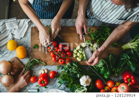 Family Hands Mixing Fresh Salad Together 128129914