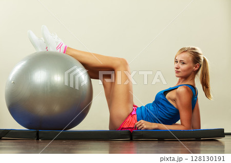 woman doing fitness exercises with fit ball 128130191