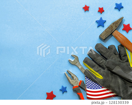 A mixed background for Labor Day in America. Tools like pliers, wrench, hammer, A mixed background for Labor Day in America. Tools like pliers, wrench, hammer, 128130339