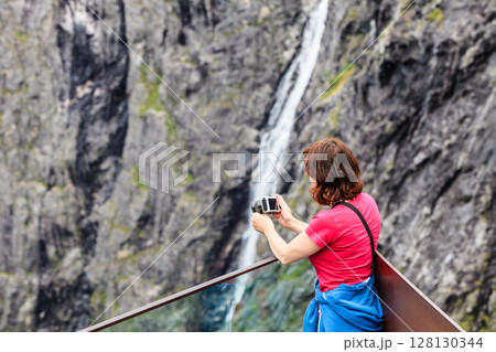 Tourist woman on Trollstigen viewpoint in Norway 128130344