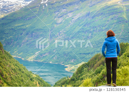 Woman tourist in norwegian mountains fjords 128130345