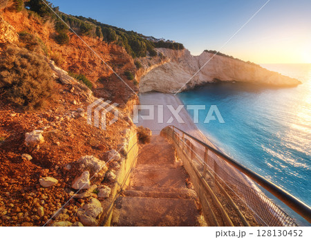 Beautiful stairs on sandy beach at sunset. Porto Katsiki Beautiful stairs on sandy beach at sunset. Porto Katsiki 128130452