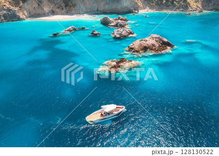 Speed boat in blue sea at sunrise in summer. Aerial view 128130522