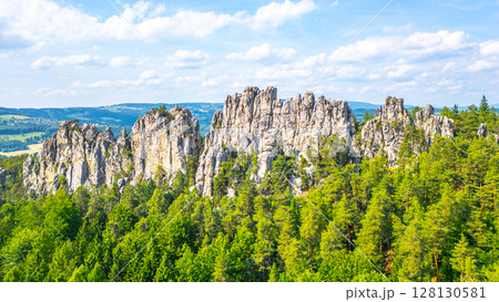 Dry rocks, Czech: Suche skaly, rise majestically in Bohemian Paradise. Surrounded by lush forests, these sandstone formations offer stunning views and unique geological features to explore. Dry rocks, Czech: Suche skaly, rise majestically in Bohemian Paradise. Surrounded by lush forests, these sandstone formations offer stunning views and unique geological features to explore. 128130581