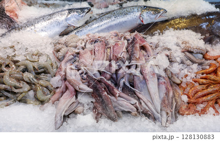 Colorful display of fresh seafood at fish market in Greece. Customers can find various fishes and marine delicacies on ice, ready for purchase and enjoyment. 128130883
