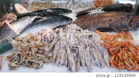 Colorful display of fresh seafood at fish market in Greece. Customers can find various fishes and marine delicacies on ice, ready for purchase and enjoyment. 128130900