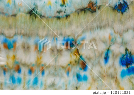 abstract pattern on silk fabric texture in blue, yellow, green colors abstract pattern on silk fabric texture in blue, yellow, green colors 128131821