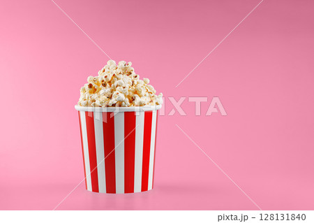 Classic red striped popcorn cardboard cup on Red background Classic red striped popcorn cardboard cup on Red background 128131840