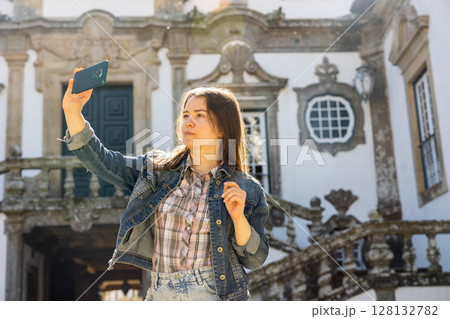 Woman with phone at Mateus Palace, Portugal Woman with phone at Mateus Palace, Portugal 128132782