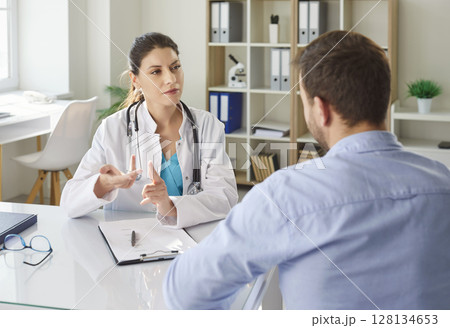 Doctor Consulting Male Patient In Hospital 128134653