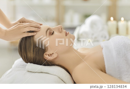 Cosmetologist Massaging Woman Face In Beauty Salon 128134834