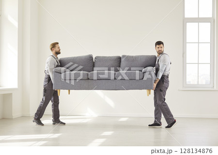 Two trained furniture movers team, delivering sofa, upholstery, repair services advertisement 128134876