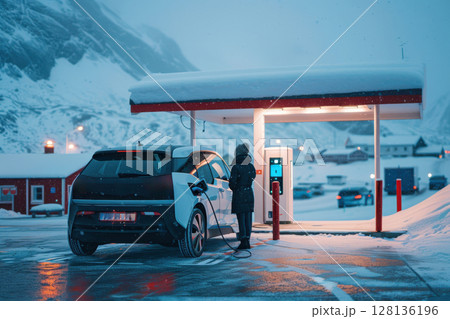 A car is charging at a charging station in the snow 128136196