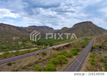 Highway intersection in desert landscape of Sunflower, Arizona roads with dramatic mountains rise Beeline Highway in Maricopa County Sonoran desert. 128138509