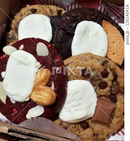 Freshly baked cookies with a golden-brown finish and chocolate chips. Perfectly crisp on the edges with a soft center, offering a delicious, comforting treat for any occasion. 128140419