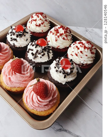 A delightful cupcake topped with rich frosting and decorative sprinkles. Perfect for dessert photography, showcasing the charm and sweetness of baked goods, ideal for parties and celebrations. A delightful cupcake topped with rich frosting and decorative sprinkles. Perfect for dessert photography, showcasing the charm and sweetness of baked goods, ideal for parties and celebrations. 128140546