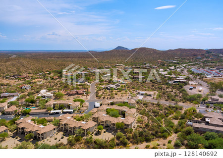 Mirage Cove Condominiums in Fountain Hills, Arizona residential development features tan colored buildings with parking areas surrounding Sonoran desert landscape 128140692