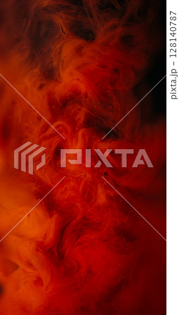 Color mix. Ink background. Defocused orange red smoke splash glitter liquid spreading on creative acrylic dark black abstraction. Color mix. Ink background. Defocused orange red smoke splash glitter liquid spreading on creative acrylic dark black abstraction. 128140787
