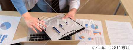 Business team hands analyze financial data charts reports strategic meeting discussion office 128140991