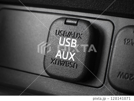 Closeup of car USB port and AUX input. Automotive connectivity in-car audio and charging. 128141071