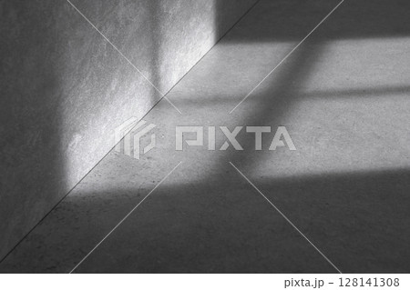 Concrete background that can be used in various designs with shadows of sunlight through the window. 128141308