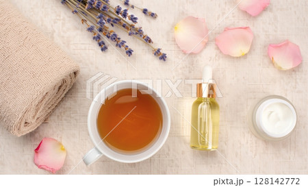 a cup of hot tea with rose petals 128142772