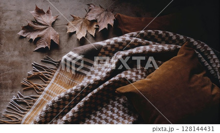 Checkered blanket with autumn leaves. Fall season concept Checkered blanket with autumn leaves. Fall season concept 128144431