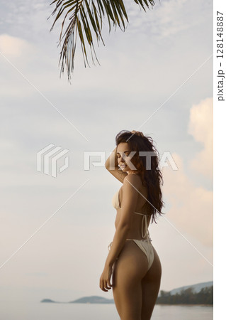 Beautiful body woman on the beach. Sexy girl in Bikini at sunset time 128148887