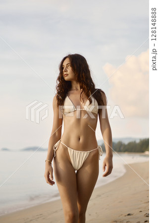 Beautiful body woman on the beach. Sexy girl in Bikini at sunset time 128148888