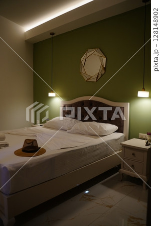 Cozy Bedroom With Hat on Bed and Elegant Decor Cozy Bedroom With Hat on Bed and Elegant Decor 128148902