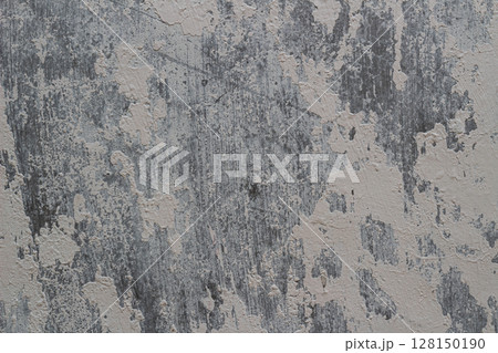 Close-up detail of old weathered concrete wall with peeling white paint texture 128150190