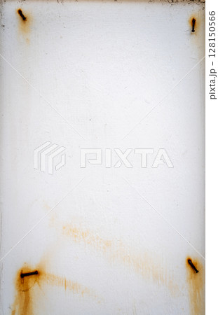 Rusty nails on a white wooden frame with peeling paint Rusty nails on a white wooden frame with peeling paint 128150566