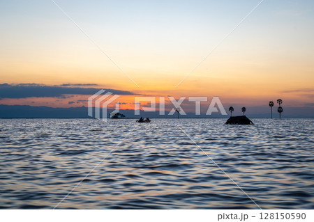 Boat at sunset on Lake Tempe, Sulawesi, Indonesia 128150590