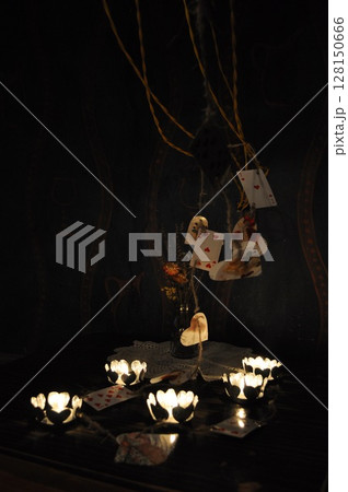 Vintage still life with candles in darkness and playing cards 128150666