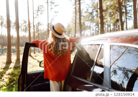 Stopping during a car trip. Young woman enjoying nature. Journey by car. Lifestyle, travel, tourism 128150914