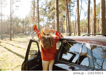 Stopping during a car trip. Young woman enjoying nature. Journey by car. Lifestyle, travel, tourism 128150915
