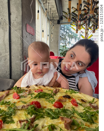 Mother and Baby Enjoying Pizza at a Restaurant 128151004