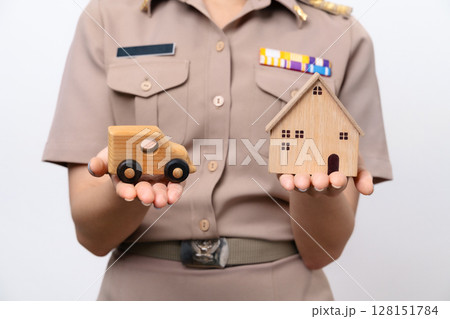Young Thai Asian Teacher in the uniform is holding the wooden car and wooden house 128151784