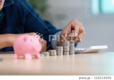 Counting Coins for Savings. Close-up of hands stacking coins with piggy bank. Counting Coins for Savings. Close-up of hands stacking coins with piggy bank. 128152050
