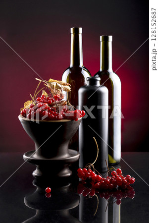 Still life with berries of viburnum red and bottles 128152687